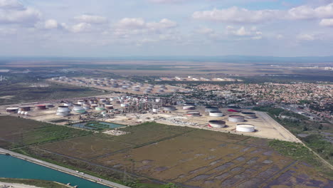 Aerial-shot-of-petrol-oil-gas-storage-tanks-mediterranean-shore-France-sunny-day
